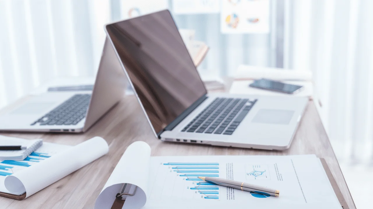 financial charts table with laptop 1