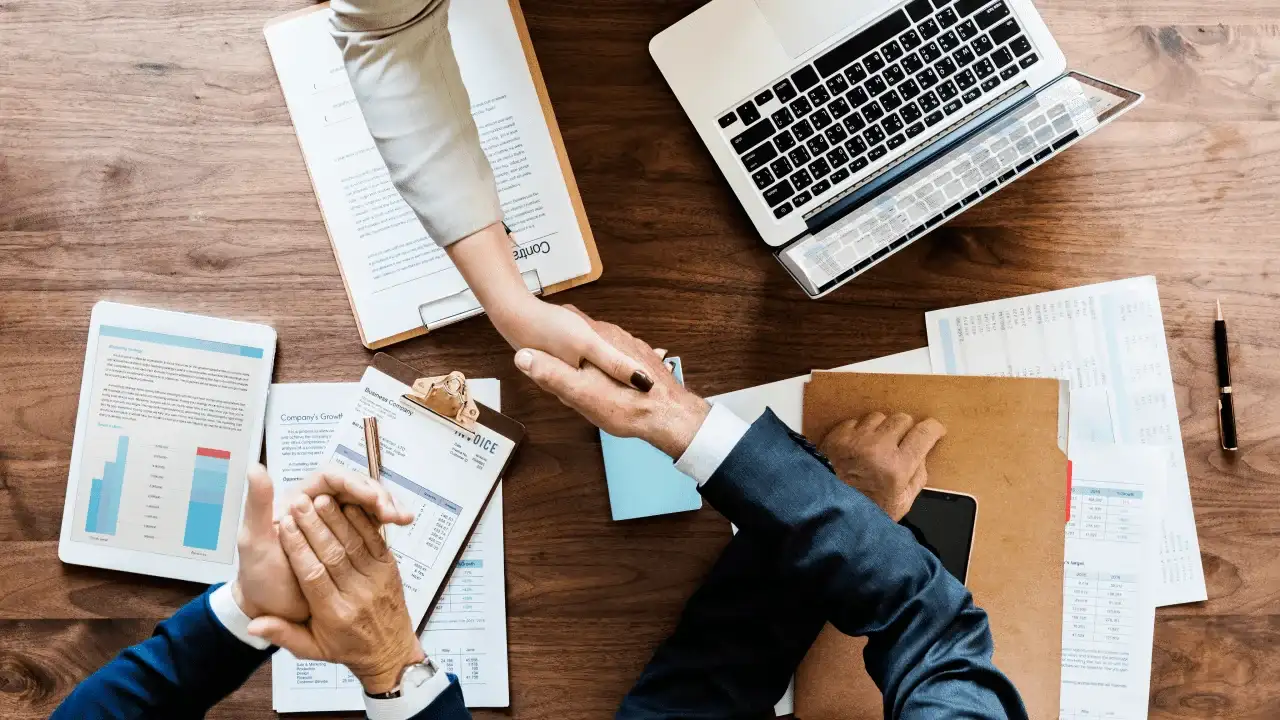 business people shaking hands together 1 11zon