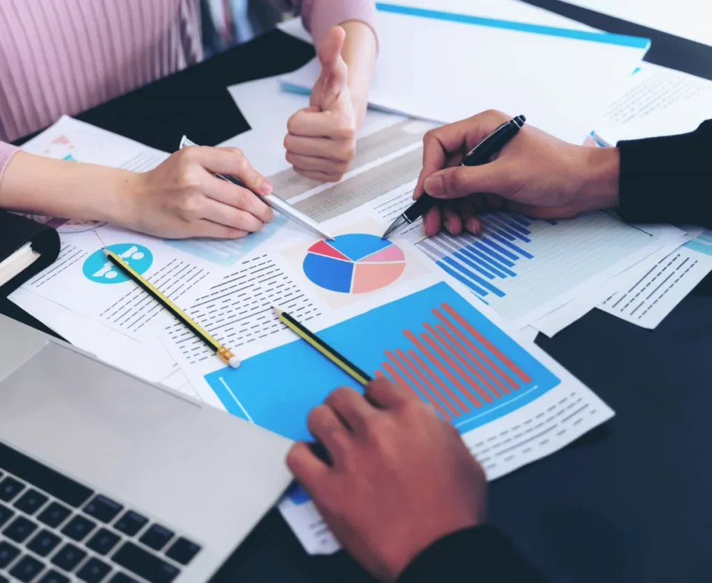close up hand of business man busy at office desk on notebook and documents working 11zon (1)